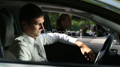 Frustrated man driving car at traffic jam