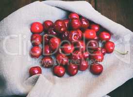 Ripe red cherry on a gray napkin