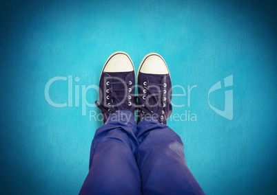 Black shoes on feet with blue background