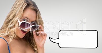Surprised woman with speech bubble holding her sunglasses against grey background