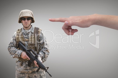 Hand pointing at soldier against grey background