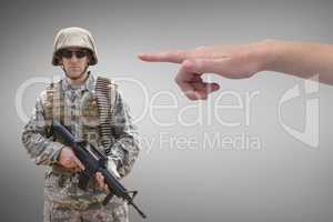 Hand pointing at soldier against grey background