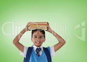 Schoolboy holding books in front of green background