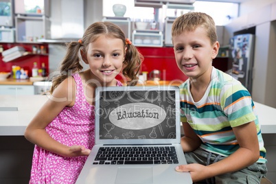 Kids looking at a computer with school icons on screen