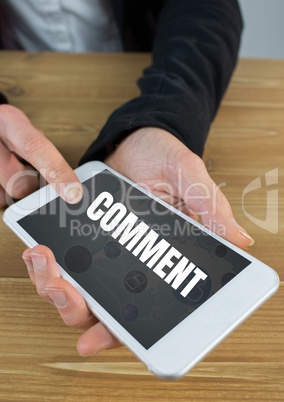 Comment text and graphic on phone screen with hands