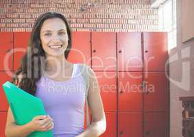 female student holding folder in front of lockers