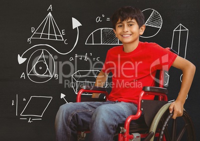 Disabled boy in wheelchair in front of blackboard with diagram drawings