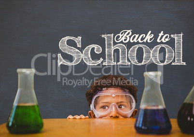 Student boy hiding behind a table against blue blackboard with back to school text