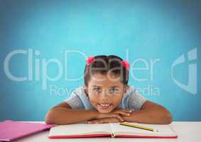 Schoolgirl at desk with blue background