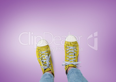 Yellow shoes on feet with purple background