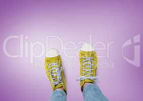 Yellow shoes on feet with purple background