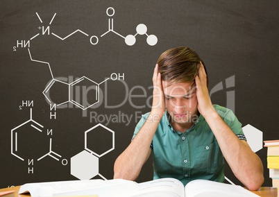 Worried student boy at table reading against grey blackboard with school and education graphic