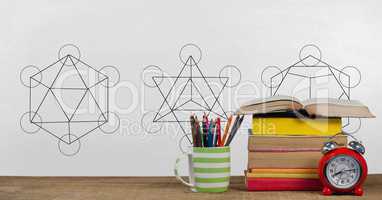 Books on the table against white blackboard with education graphics and back to school text