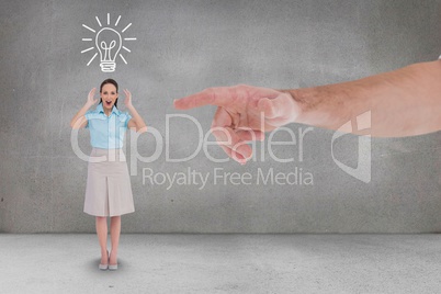 Hand pointing at happy business woman against grey background with a bulb icon