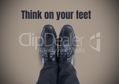 Think on your feet text and Black shoes on feet with brown background