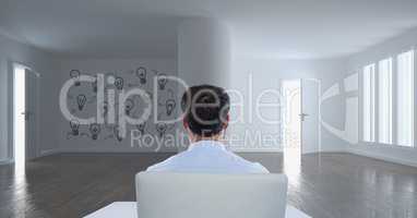 Business man sitting in a 3D room with a conceptual graphic on the wall