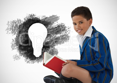 Boy reading next to charcoal light bulb