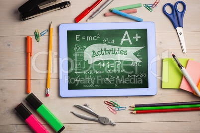 Tablet on a school table with school icons on screen