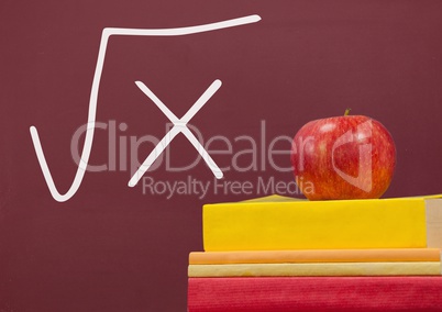 Books on the table against red blackboard with education and school graphics