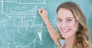 Woman drawing diagrams on blackboard