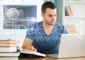 Male Student studying with book and laptop and science education interface graphics overlay