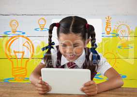 Schoolgirl on tablet with colorful light bulb graphics