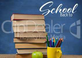 Back to School text on blackboard and Books on Desk foreground