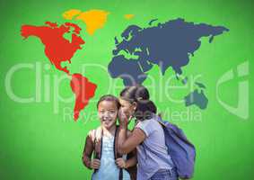 Schoolgirls whispering in front of colorful world map