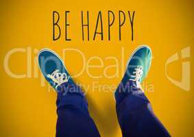 Be happy text and Blue shoes on feet with yellow background