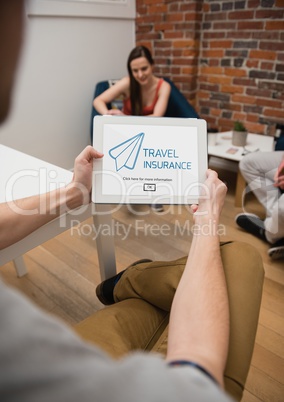 Man holding a tablet with travel insurance concept on screen