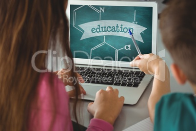 Kids using a computer with school icons on screen