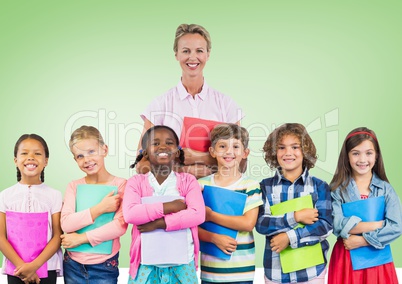Kids holding schoolbooks with teacher in front of green background