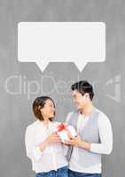 Couple with speech bubble smiling against grey background
