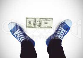 Dollar note on ground and Blue shoes on feet with white background