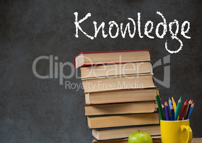 Knowledge text on blackboard with stack of books on desk