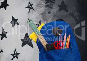 Schoolbag on Desk foreground with blackboard graphics of stars