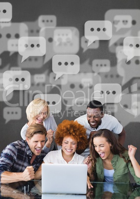 Excited business people with speech bubbles looking at a computer against grey background
