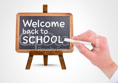 Hand writing Welcome back to school text on blackboard