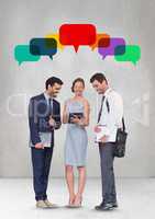 Business people with speech bubble looking at a tablet against grey background
