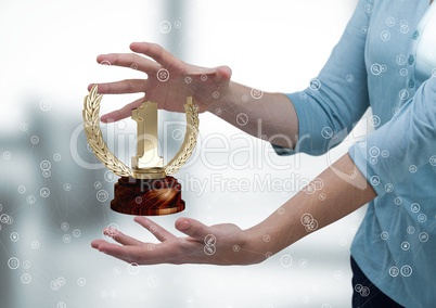 Woman with a trophy on hands