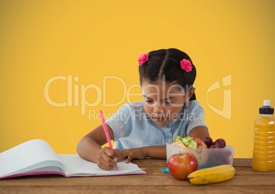 Schoolgirl writing with healthy lunch