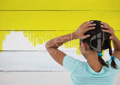 Girl looking at painted yellow wall