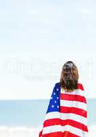 Woman holding a USA flag in the beach