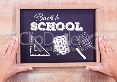 Back to school text on blackboard with chalk and stationery