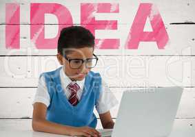 Schoolboy on laptop with idea text