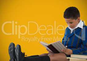 Boy reading in front of yellow background