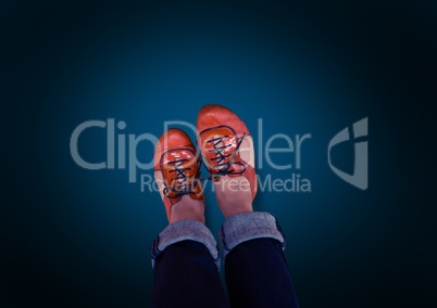 Red shoes on feet with blue background