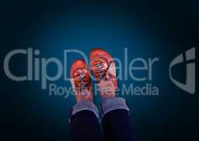 Red shoes on feet with blue background