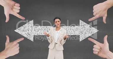 Hands pointing at confused business woman against grey background with arrows