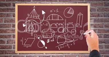 Hand drawing diagrams on blackboard